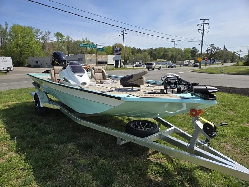 Slide: The Image of 2025 Avid 18 Vertex boat on trailer, parked on grass near road. - 2