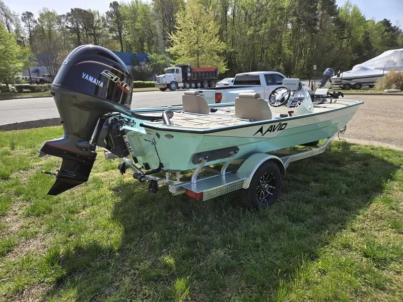 Slide: The Image of 2025 Avid 18 Vertex boat with Yamaha motor on a trailer, parked on grass. - 5