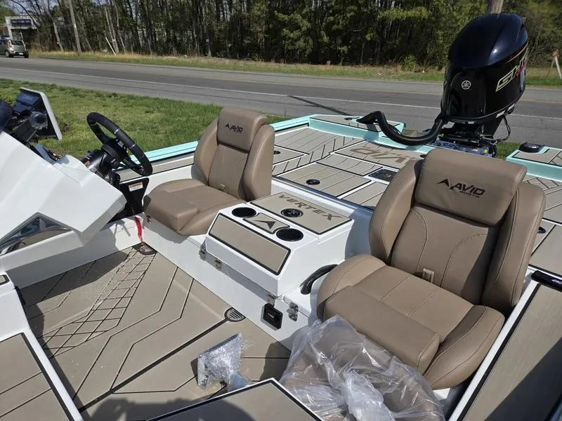 Slide: The Image of 2025 Avid 18 Vertex boat interior with tan seats and modern console design. - 6