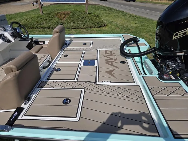 Slide: The Image of 2025 Avid 18 Vertex boat deck with seating and motor, featuring sleek design and branding. - 7