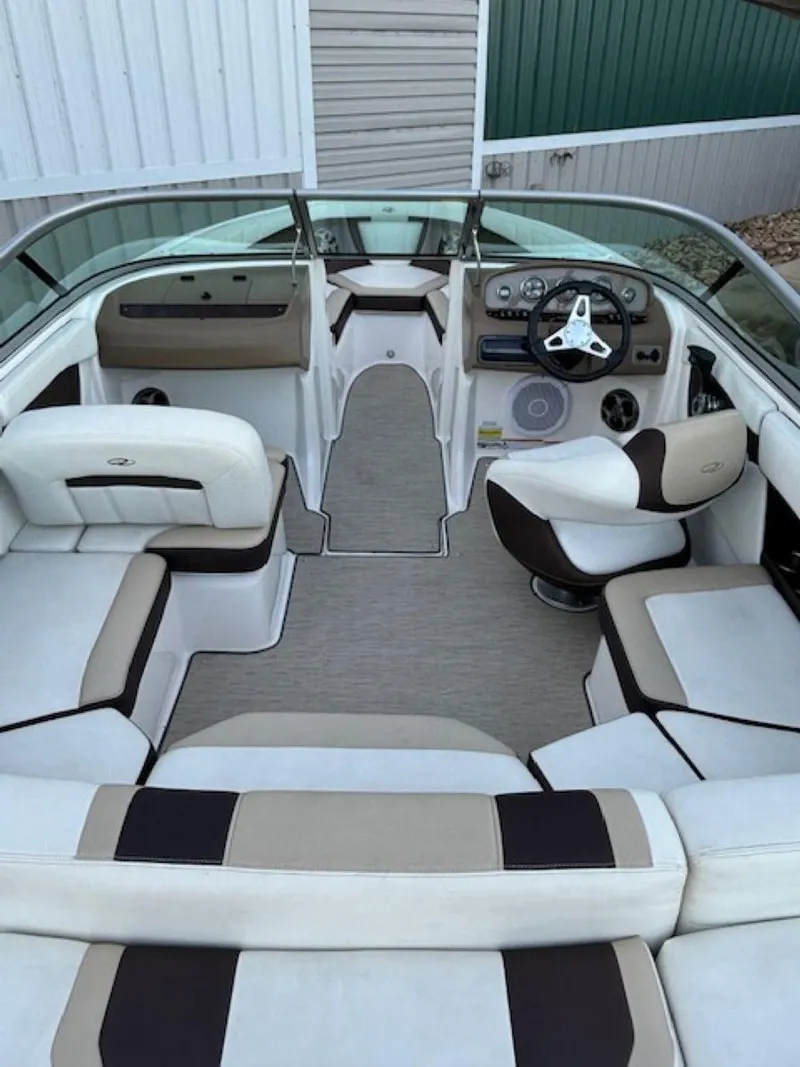 Slide: The Image of Interior of a 2015 Regal 2000 ES boat with white and brown seating. - 11