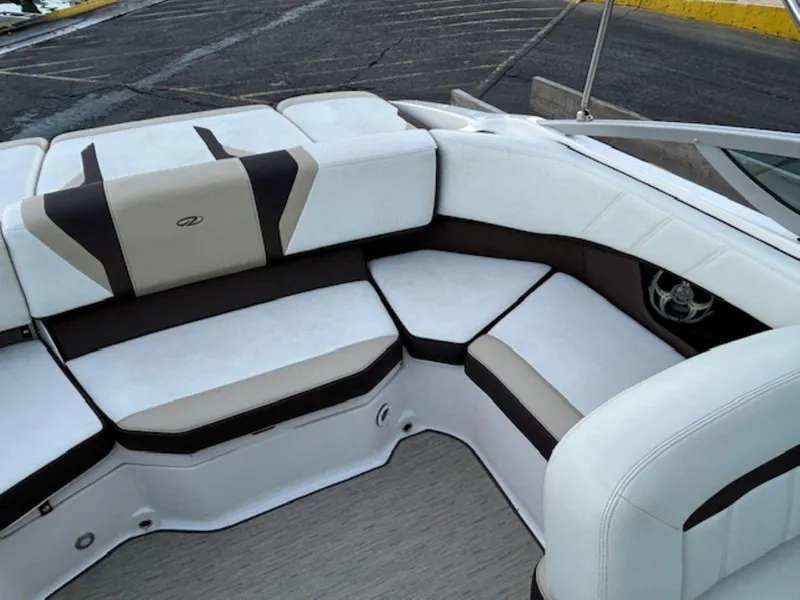 Slide: The Image of 2015 Regal 2000 ES boat interior with white and brown cushioned seating. - 13