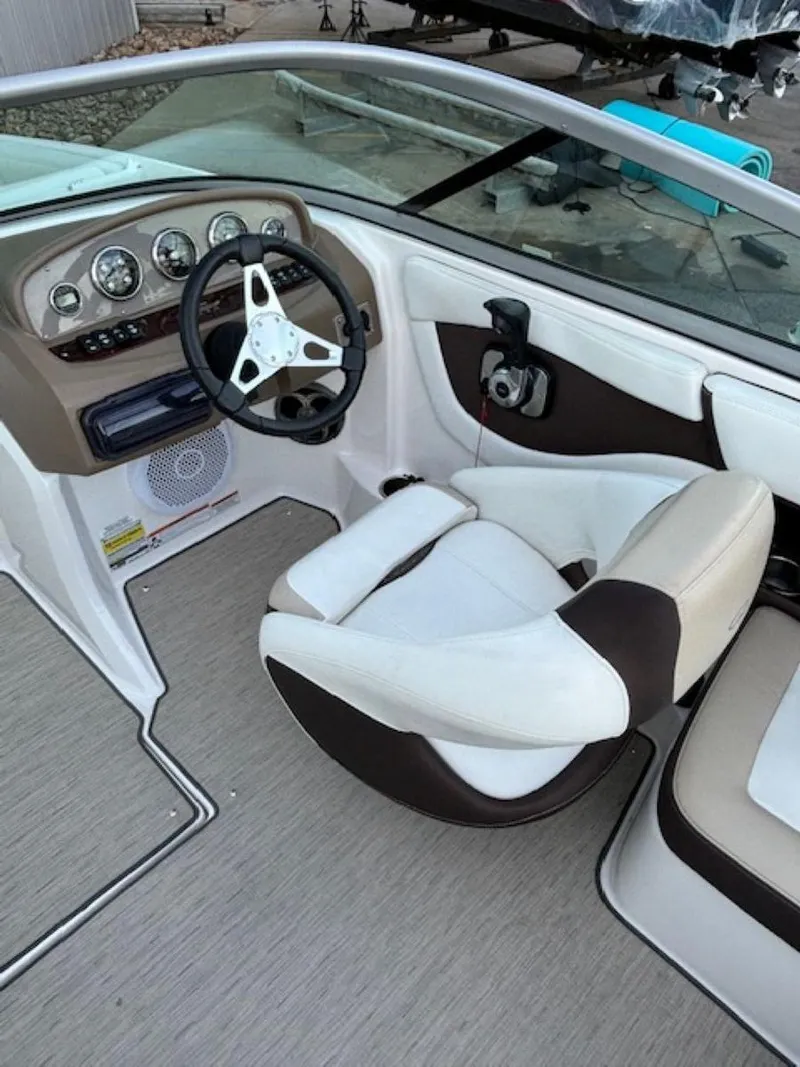 Slide: The Image of 2015 Regal 2000 ES boat interior with steering wheel and seating. - 14