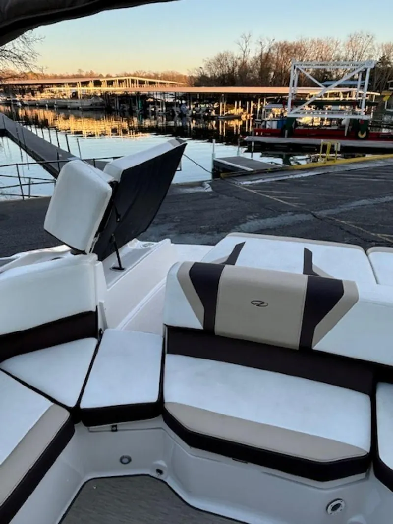 Slide: The Image of 2015 Regal 2000 ES boat interior at a serene waterfront dock. - 17