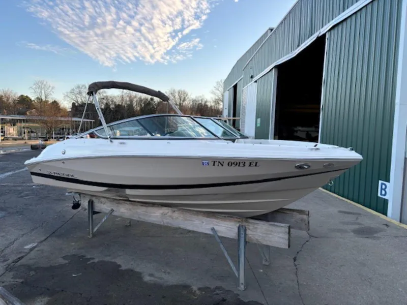 Slide: The Image of 2015 Regal 2000 ES boat on a stand near a green warehouse. - 3