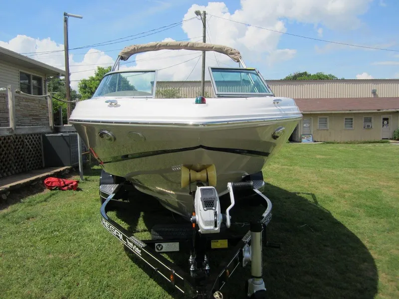 Slide: The Image of 2015 Regal 2000 ES boat on trailer, parked on grass under a clear sky. - 30