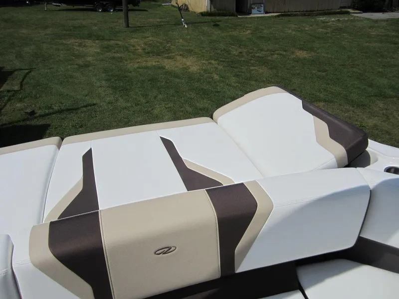 Slide: The Image of 2015 Regal 2000 ES boat seating with beige and brown upholstery on grass. - 6
