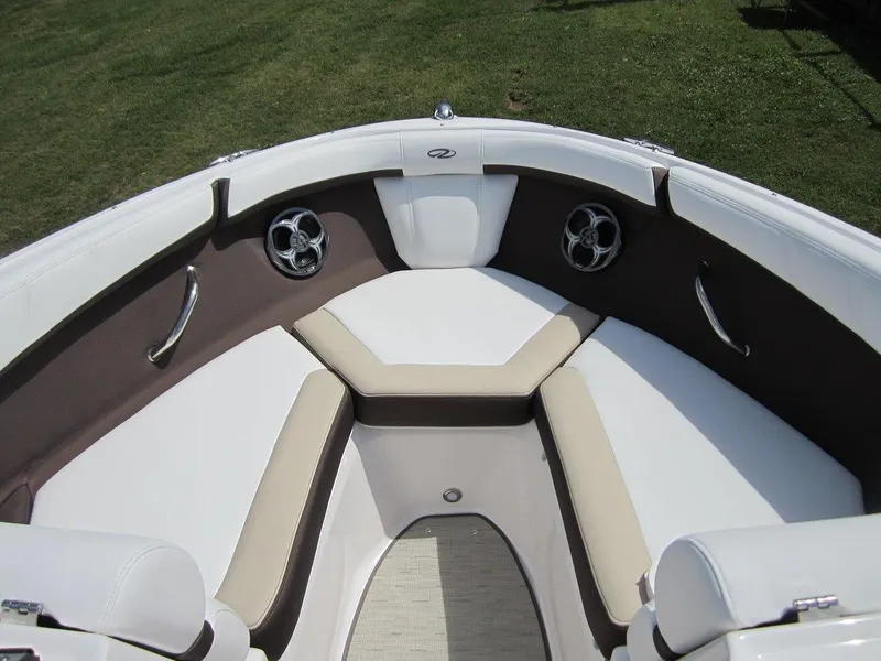 Slide: The Image of 2015 Regal 2000 ES boat interior with cushioned seating and stainless steel accents. - 9