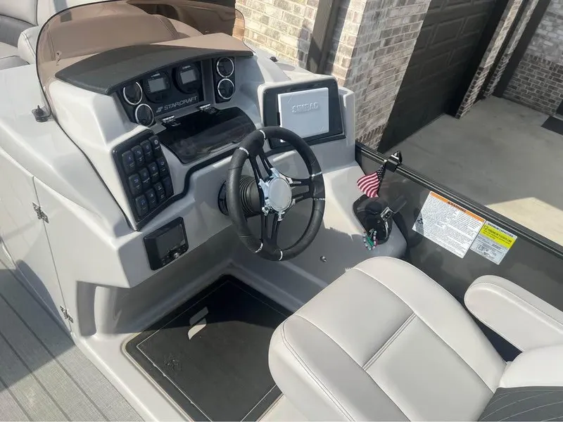 Slide: The Image of 2023 Starcraft SLS 3 Q DH boat dashboard with steering wheel and controls. - 5