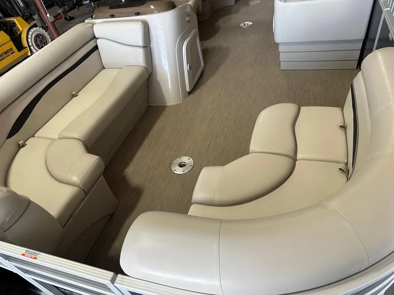 Slide: The Image of 2018 Bennington 21 SSRCX Premium boat interior with beige seating and spacious layout. - 8