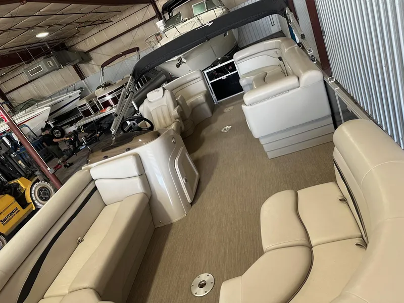 Slide: The Image of 2018 Bennington 21 SSRCX Premium pontoon boat interior in storage facility. - 9