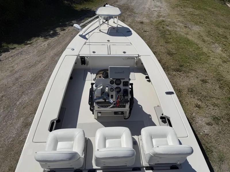 Slide: The Image of 2009 Hewes 18 Redfisher boat interior with steering console and seating. - 18