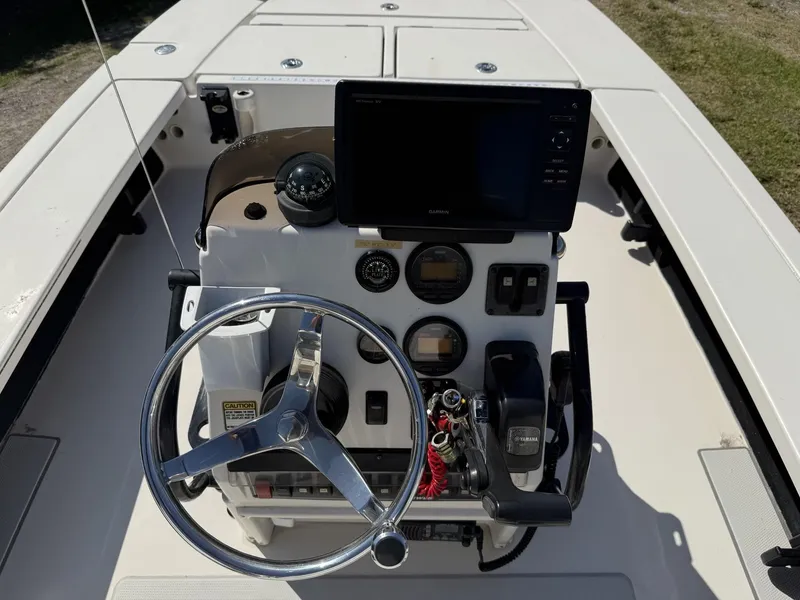 Slide: The Image of 2009 Hewes 18 Redfisher boat console with steering wheel and navigation equipment. - 21