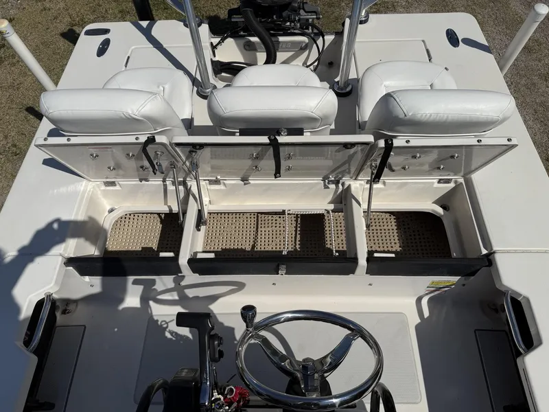 Slide: The Image of 2009 Hewes 18 Redfisher boat interior with white seats and steering wheel. - 24