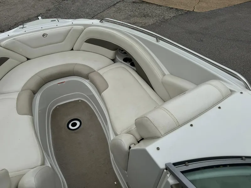 Slide: The Image of 2008 Crownline Bowrider 240 LS interior with beige seating and carpeted floor. - 11