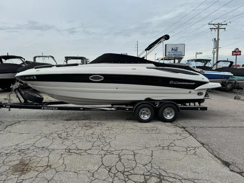 Slide: The Image of 2008 Crownline Bowrider 240 LS on trailer, parked in a marina lot. - 12