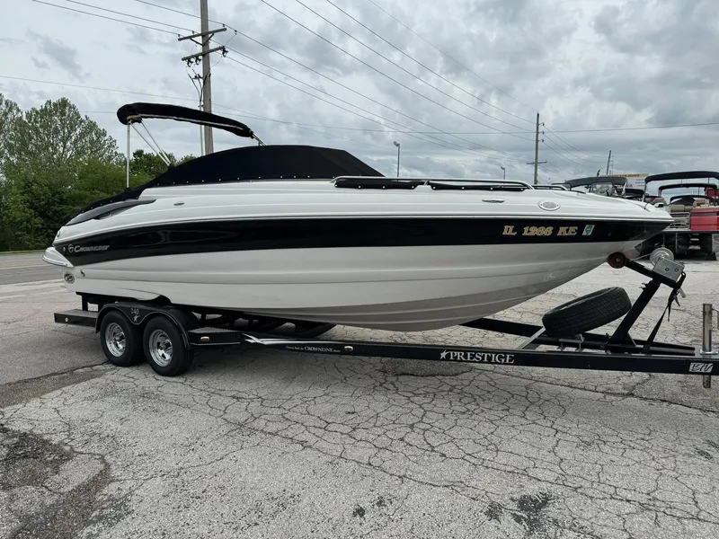 Slide: The Image of 2008 Crownline Bowrider 240 LS on trailer, parked outdoors under cloudy sky. - 16