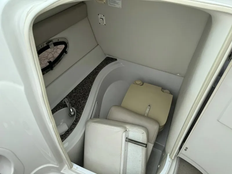 Slide: The Image of 2008 Crownline Bowrider 240 LS boat interior with compact bathroom amenities. - 17