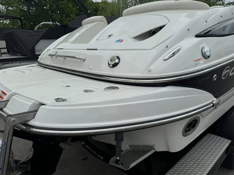 Slide: The Image of 2008 Crownline Bowrider 240 LS boat, rear view, white exterior, parked on trailer. - 19