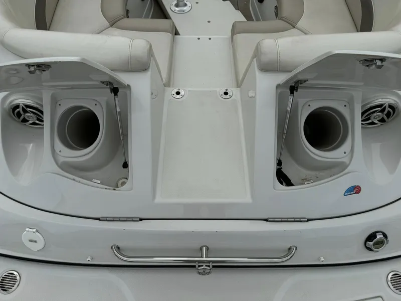 Slide: The Image of 2008 Crownline Bowrider 240 LS boat interior with open storage compartments and seating. - 4