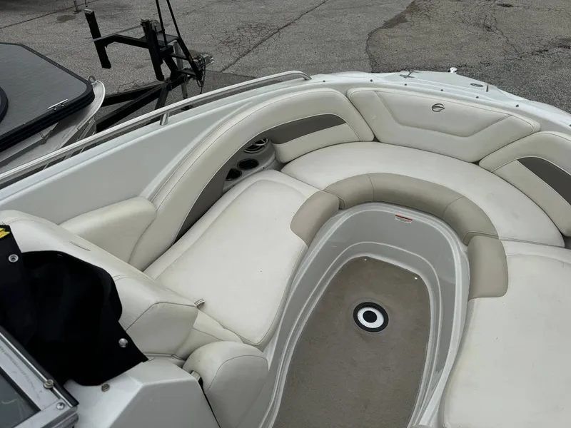 Slide: The Image of 2008 Crownline Bowrider 240 LS interior with white seating and cup holders. - 6
