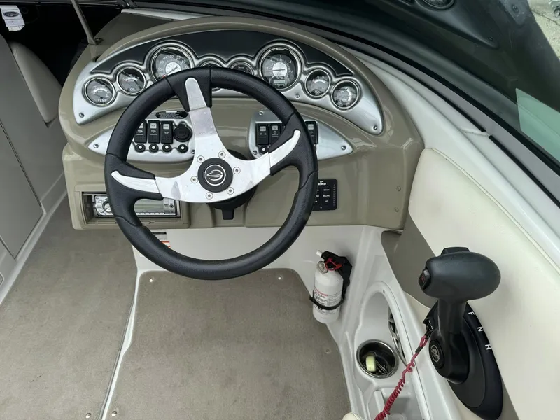 Slide: The Image of 2008 Crownline Bowrider 240 LS dashboard with steering wheel and control panel. - 8