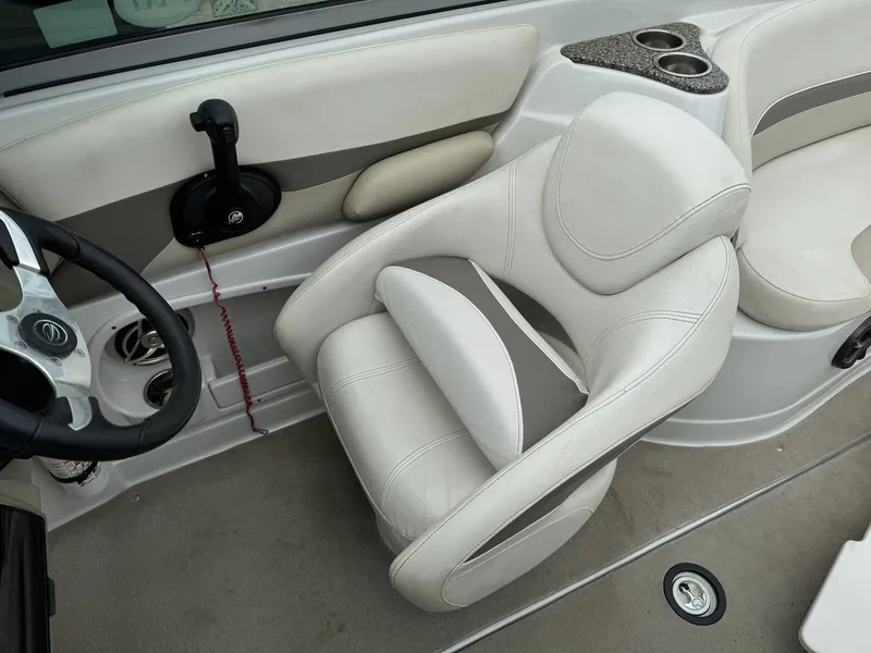 Slide: The Image of 2008 Crownline Bowrider 240 LS interior with steering wheel and white seating. - 9