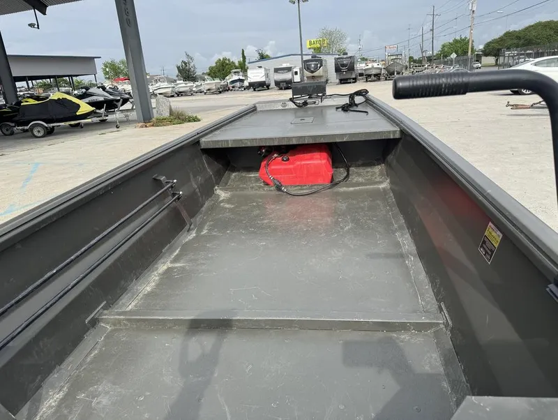 Slide: The Image of Interior of 2025 Gator Tail 1748 boat with red fuel tank, parked outdoors. - 14