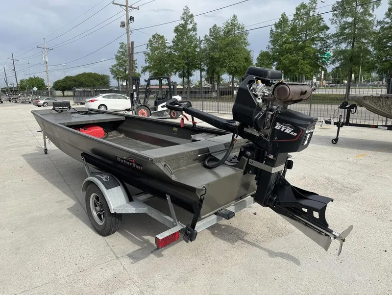 Slide: The Image of 2025 Gator Tail 1748 boat on trailer with outboard motor, parked outdoors. - 3
