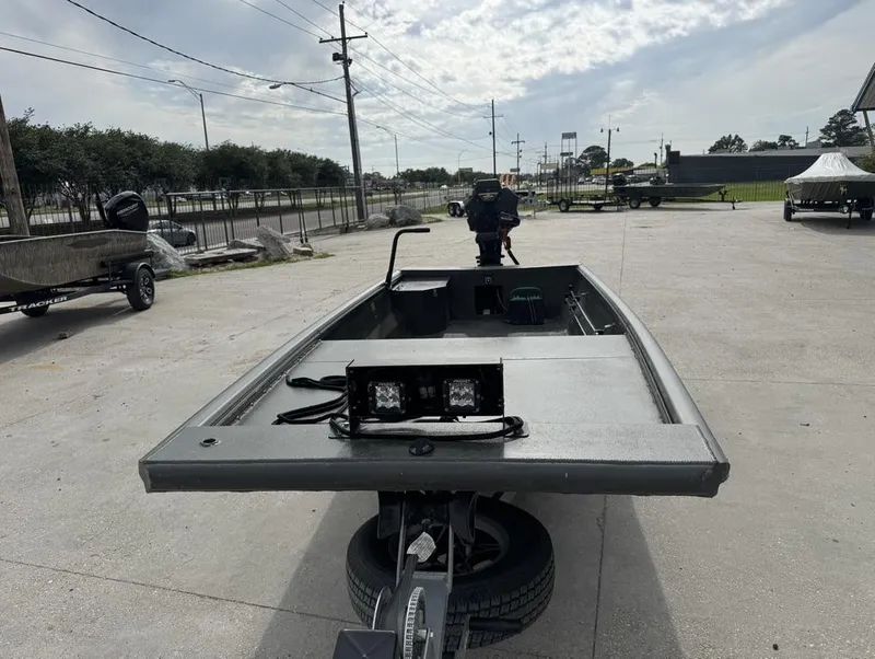 Slide: The Image of 2025 Gator Tail 1748 boat on trailer in outdoor lot, overcast sky. - 5