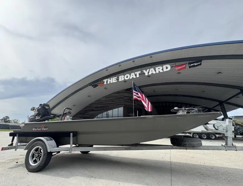Slide: The Image of 2025 Gator Tail 1748 boat on trailer at The Boat Yard, American flag displayed. - 6