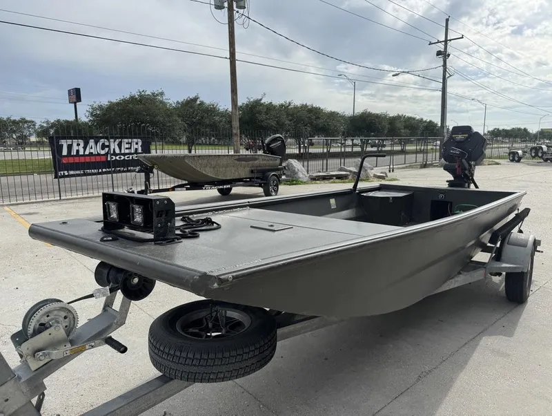 Slide: The Image of 2025 Gator Tail 1748 boat on trailer, outdoor display, overcast sky. - 8