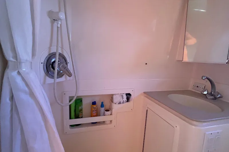 Slide: The Image of Bathroom interior of 1998 Tiara Yachts 3500 Open with shower and sink. - 15