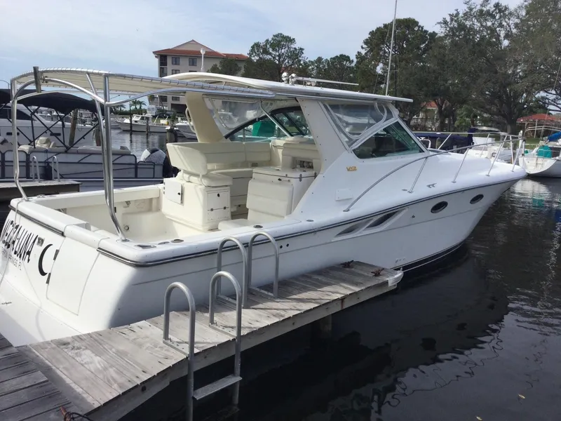 Slide: The Image of 1998 Tiara Yachts 3500 Open docked, showcasing sleek design and spacious deck. - 2