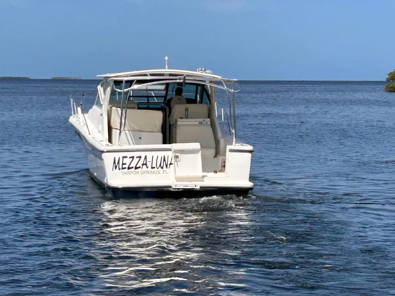 Slide: The Image of 1998 Tiara Yachts 3500 Open boat on water, rear view, clear sky. - 5