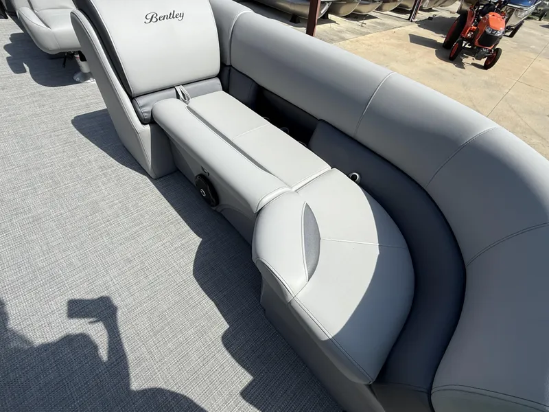 Slide: The Image of 2025 Bentley Pontoons Legacy 220 Navigator with luxurious gray seating and spacious deck. - 9