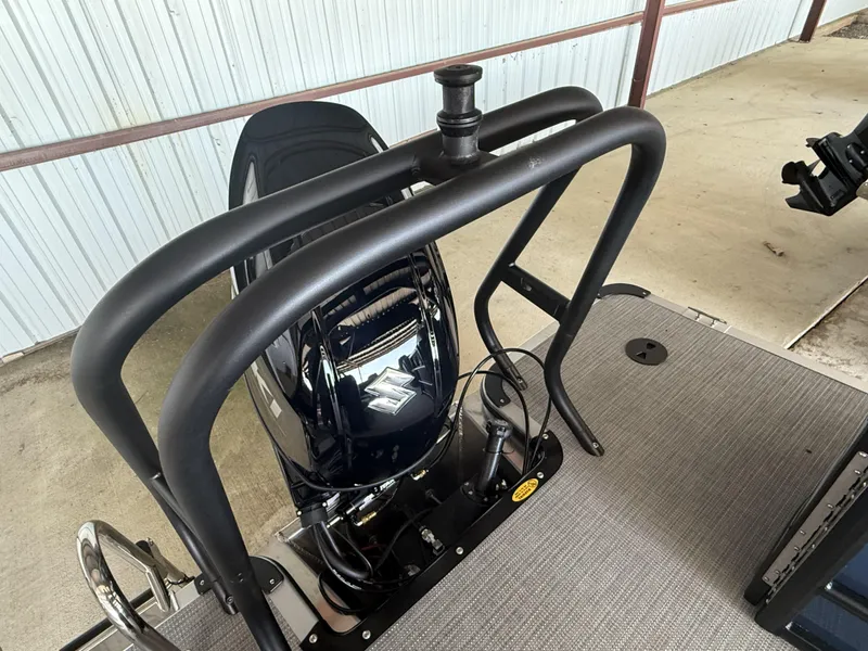 Slide: The Image of 2025 Bentley Pontoons Legacy Navigator 243 with Suzuki outboard motor, docked on a concrete surface. - 13