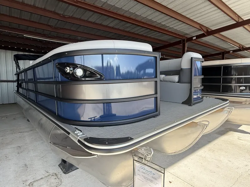 Slide: The Image of 2025 Bentley Pontoons Legacy Navigator 243 in a covered storage area. - 3