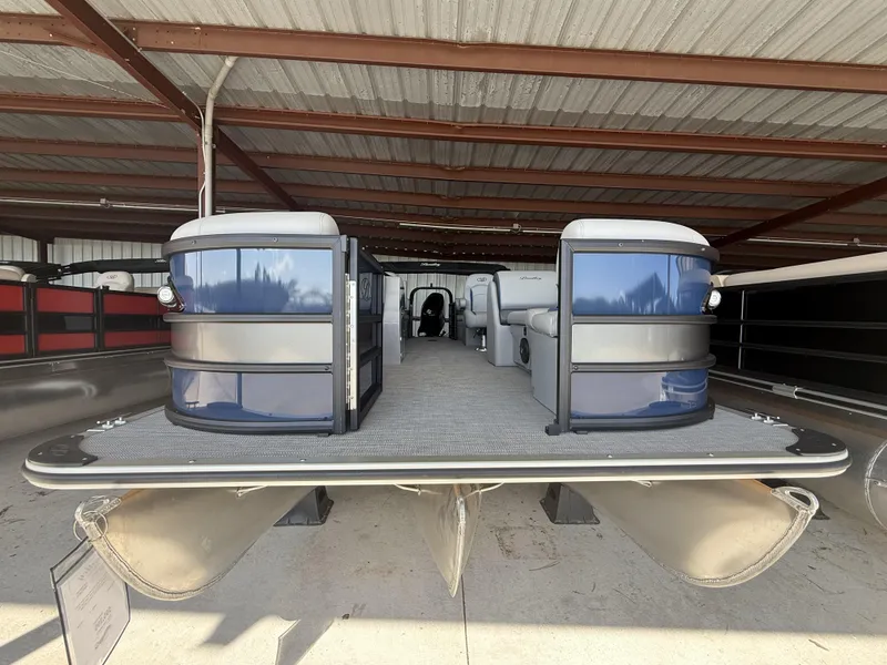 Slide: The Image of 2025 Bentley Pontoons Legacy Navigator 243 under a metal roof, showcasing sleek design and spacious interior. - 4