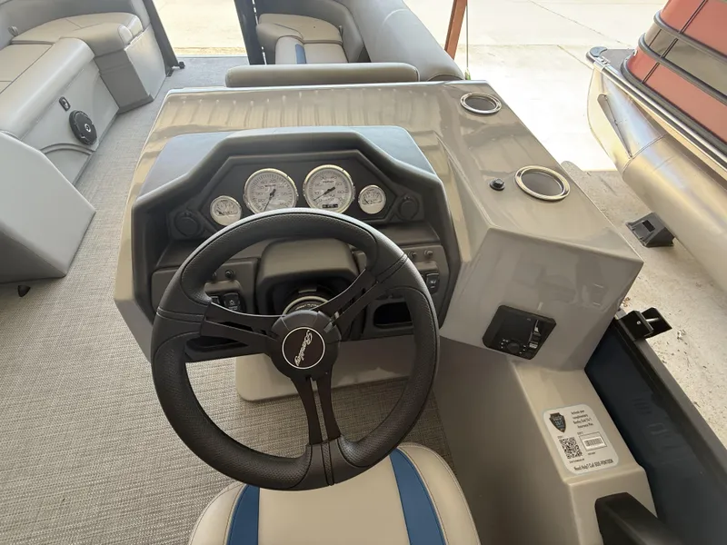 Slide: The Image of 2025 Bentley Pontoons Legacy Navigator 243 dashboard with steering wheel and gauges. - 9