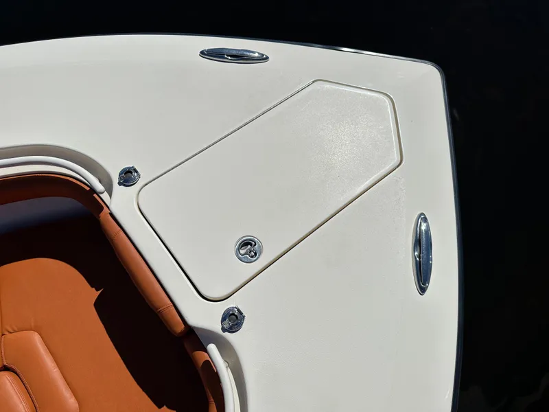 Slide: The Image of 2017 Scout 320 LXF boat deck with tan seating and storage compartment. - 20