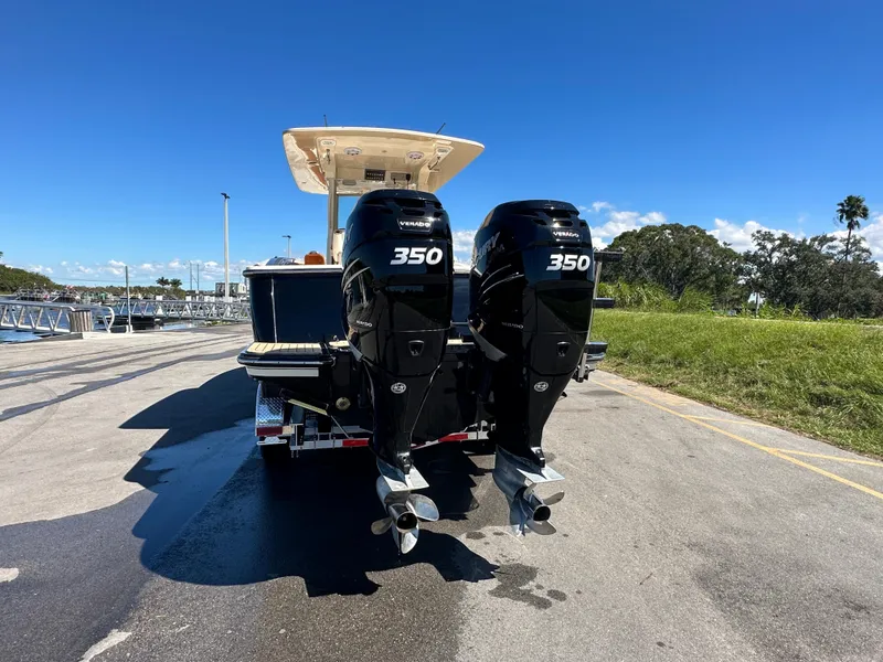 Slide: The Image of 2017 Scout 320 LXF boat with twin 350 horsepower engines on a sunny day. - 3