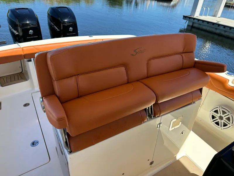 Slide: The Image of 2017 Scout 320 LXF boat with tan leather seating and dual Mercury engines. - 30
