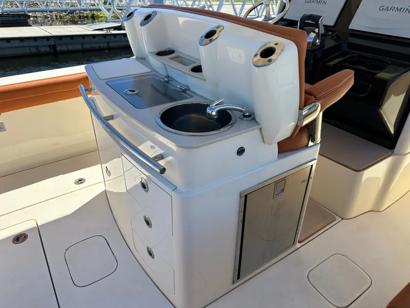 Slide: The Image of 2017 Scout 320 LXF boat interior with sink and storage compartments. - 31
