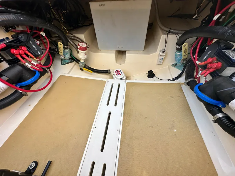 Slide: The Image of Engine compartment of a 2017 Scout 320 LXF boat, showing wiring and components. - 33