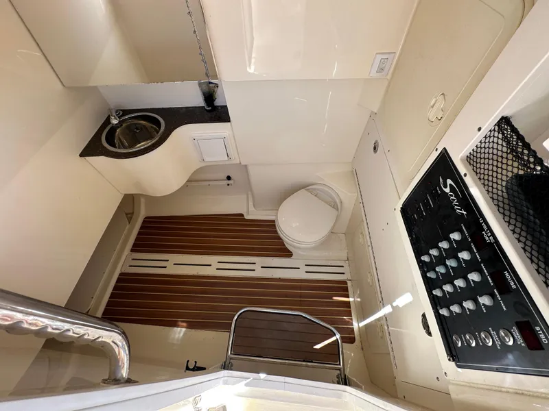 Slide: The Image of 2017 Scout 320 LXF boat interior with sink, toilet, and control panel. - 36