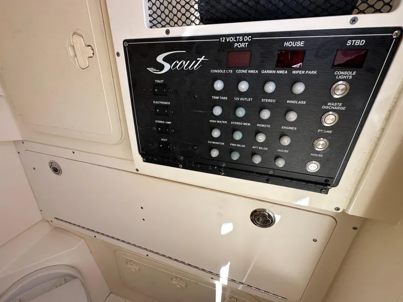 Slide: The Image of Control panel of a 2017 Scout 320 LXF boat, featuring various switches and indicators. - 37