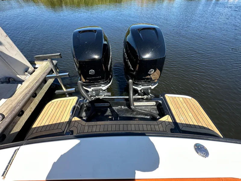 Slide: The Image of 2017 Scout 320 LXF boat with twin outboard engines on a calm water surface. - 39