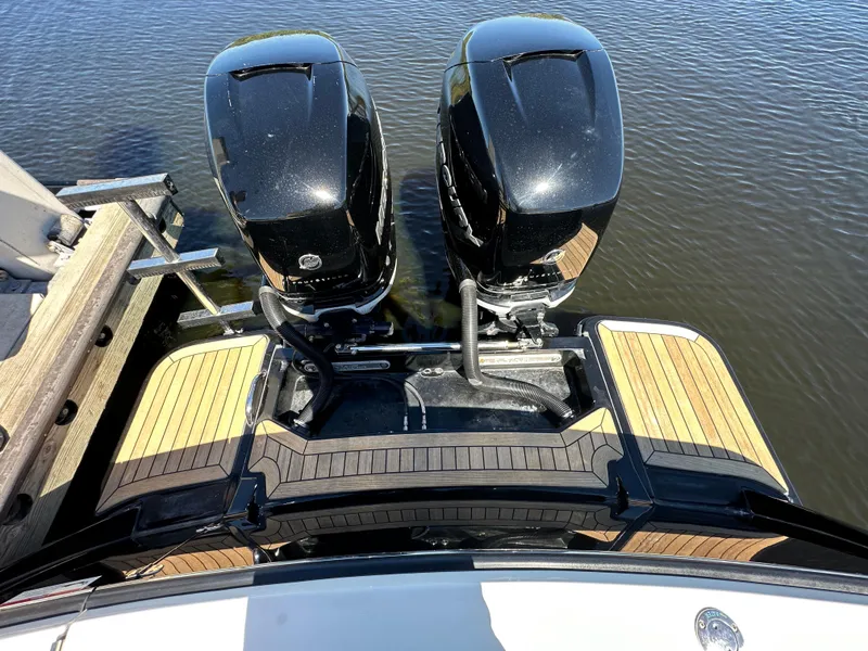 Slide: The Image of 2017 Scout 320 LXF boat with dual outboard motors on water. - 40