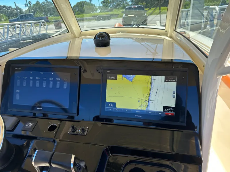 Slide: The Image of Dashboard of a 2017 Scout 320 LXF boat with Garmin navigation displays. - 41
